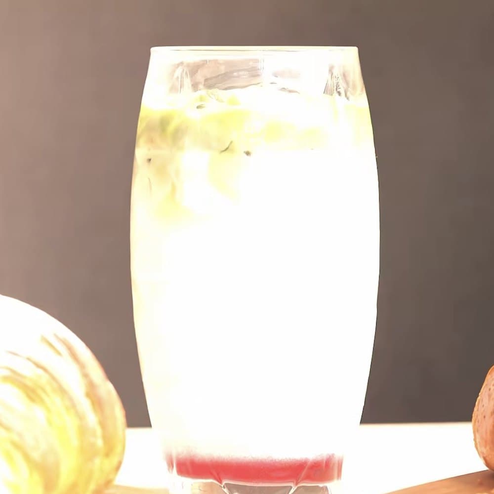 A tall glass of cloudy house lemonade.